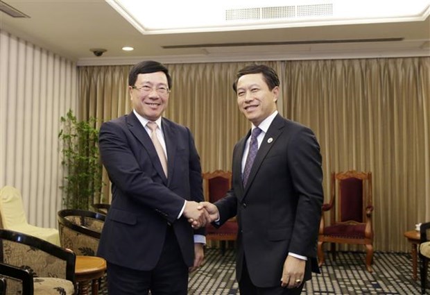 Вице-премьер Фам Бинь Минь провел двусторонние встречи с министрами Китая и Лаоса hinh anh 2