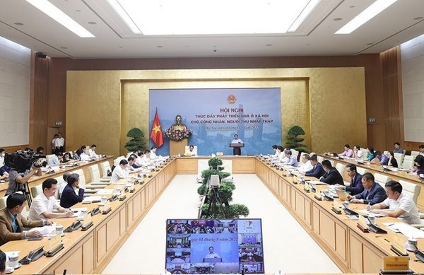 Премьер-министр провел совещание по развитию социального жилья hinh anh 1